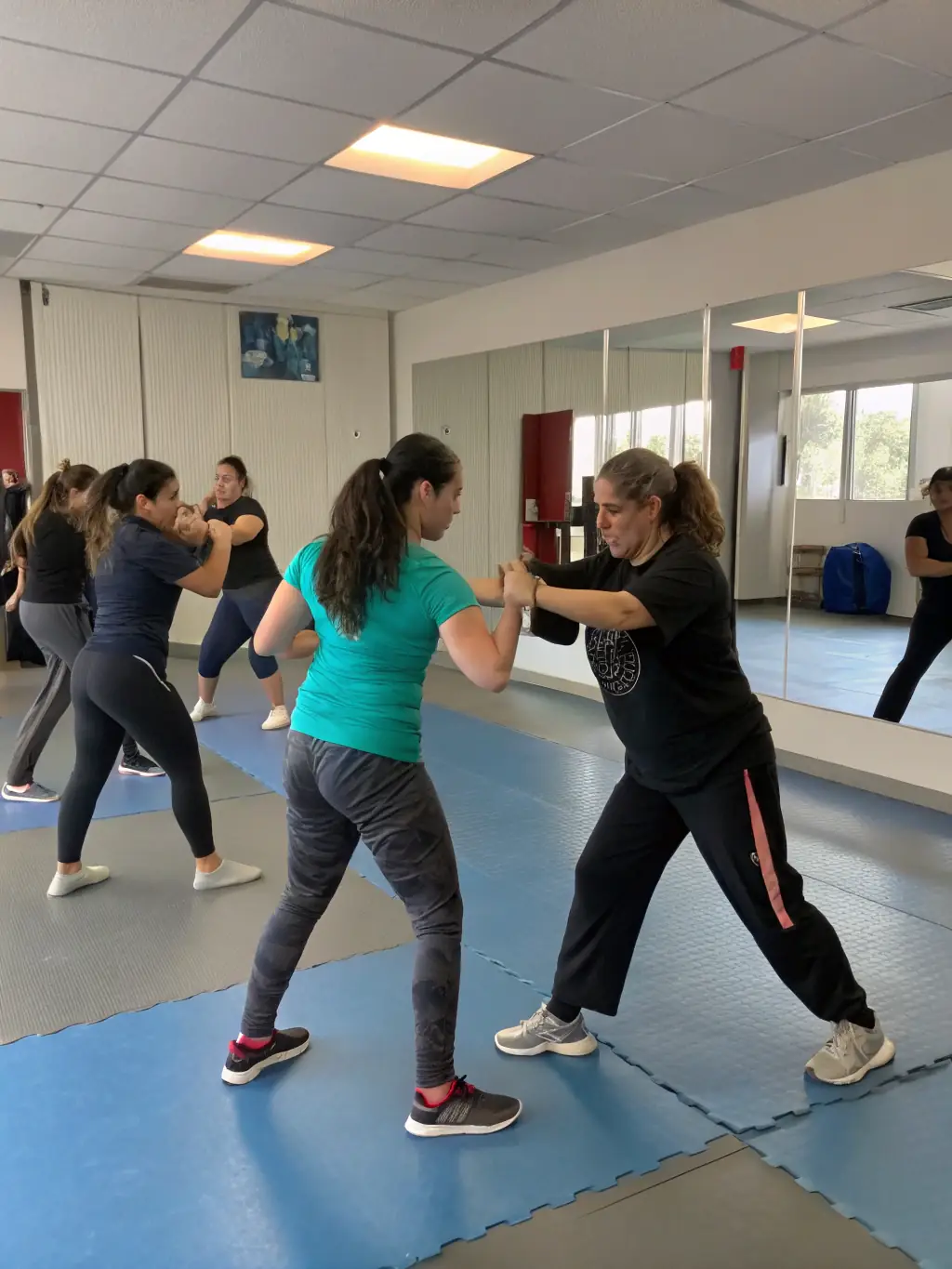 A diverse group of students participating in a self-defense workshop, learning practical techniques.